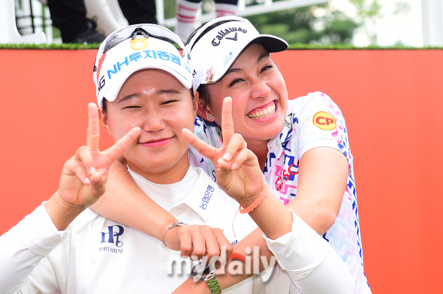 정윤지(왼쪽)와 2022 LPGA 신인왕 아타야 티띠꾼이 장난스러운 포즈를 취하고 있다.