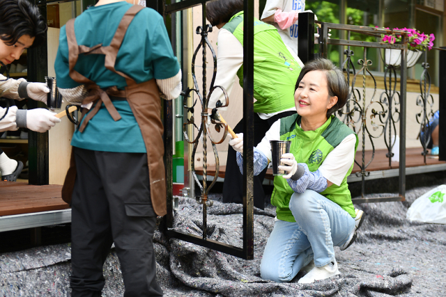 서창희(오른쪽 첫 번째) 코오롱사회봉사단장이 28일 코오롱그룹 집중 봉사주간으로 진행하는 ‘드림 파트너스 위크’ 일환으로 서울 마포의 성산행복한홈스쿨에서 테라스 목재 개보수 및 화단 가꾸기 활동을 진행하고 있다./코오롱그룹